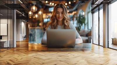 Professional female employee or a businesswoman using a laptop in a modern office. Copy space Wall mural