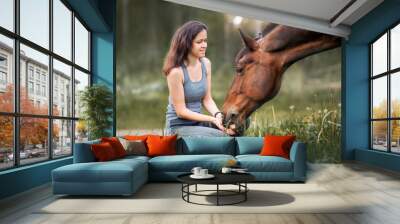 Young woman  with her horse Wall mural