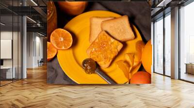 slices of toasted bread with orange marmalade on a plate with oranges on the side Wall mural