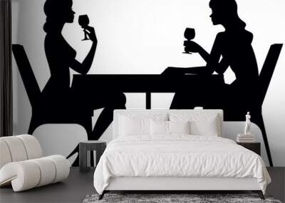 Two young women friends sit at a table of a cafe or restaurant and drink from glasses black stylized silhouette on a white background vector illustration Wall mural