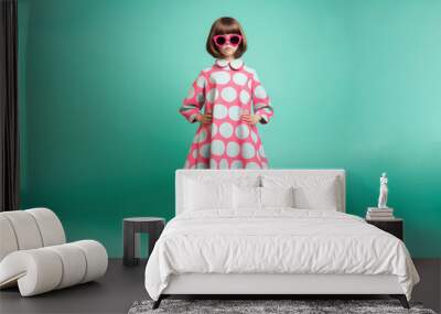 Generative AI, a little girl with a trendy hairstyle in an elegant dress in the mod style stands on a colorful rich background, fashionable child, children's fashion, 50s clothes, shop, magazine Wall mural