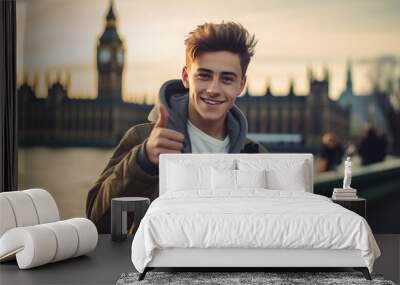 smiling happy young guy against the backdrop of Big Ben in London, boy, teenager, traveling to another country, student, studying English, schoolboy, work and study abroad, Europe, England, thumbs up Wall mural