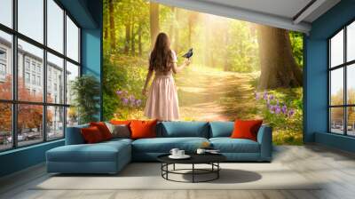 Lady girl with long hair in dress with bird in hand walking in fantasy enchanted fairy tale spring forest with blooming flowers and sun rays, mysterious road goes through trees in magical elvish wood Wall mural