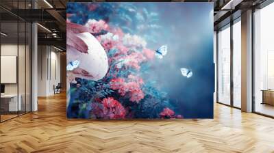 Magical fantasy elf or gnome mushroom house with window in enchanted fairy tale forest, fabulous blooming rose flower garden, flying butterflies on mysterious blue background, shine moon ray in night Wall mural