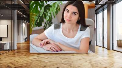 Young woman at home in her living room  Wall mural