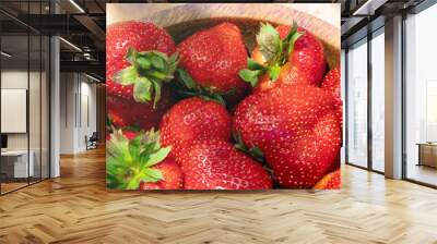 Fresh beautiful strawberries in wooden bowl top view. Strawberry fruits on wooden table copy space. Wall mural