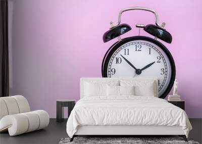 vintage black alarm clock on pink background Wall mural