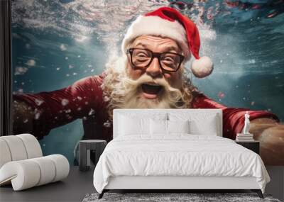 Santa Claus swim and relax in blue transparent pool water. Merry Christmas and Happy New Year travel destinations concept. Wall mural