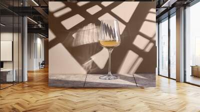 wine in a glass on a beige background Wall mural