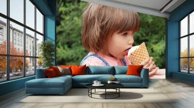 Cute girl are eating icecream Wall mural