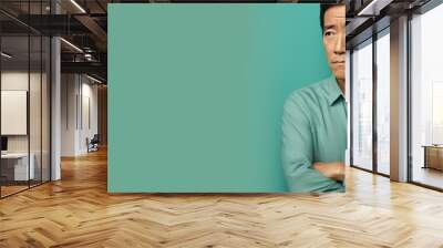 Turquoise background sad Asian man. Portrait of older mid-aged person beautiful bad mood expression boy Isolated on Background depression anxiety fear burn out health issue  Wall mural