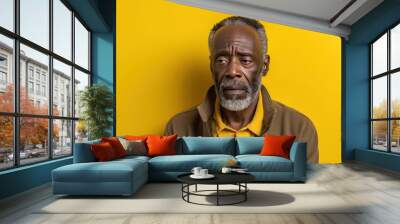 Yellow background sad black American independent powerful man. Portrait of older mid-aged person beautiful bad mood expression isolated on background Wall mural