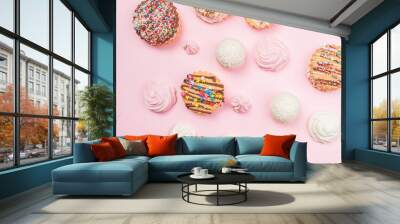 Handmade cookies and marshmallows lie on a pink background. Wall mural