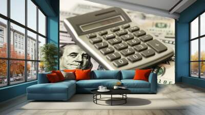 Calculator lying on one hundred dollar bills calculating financial savings Wall mural