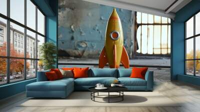 Colorful vintage toy rocket stands ready for imaginary launch in an old rustic setting Wall mural