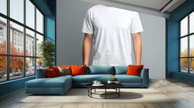 Front view of a blank white t-shirt on a man against a grey background, ideal for design mockups Wall mural