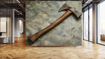 Sharp hand forged axe with wooden handle is lying on a concrete background Wall mural