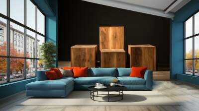 Three simple wooden cubes staged on a wooden floor against a dark backdrop, showcasing natural wood texture Wall mural