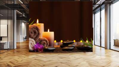 Aromatherapy, spa, beauty treatment and wellness background with massage stone, orchid flowers, towels and burning candles... Wall mural