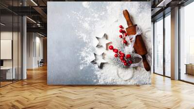 Bakery background for cooking christmas baking with rolling pin and scattered flour decorated with fir tree top view. Wall mural