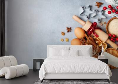 Bakery background with ingredients for cooking christmas baking decorated with fir tree. Flour, brown sugar, eggs and spices on kitchen table top view. Wall mural