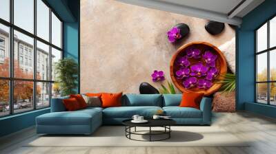 Beauty, spa background with massage stone and flowers on brown background top view. Relaxation and wellness concept. Flat lay. Wall mural