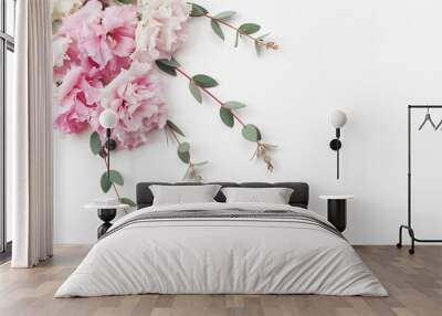 Bunch of beautiful flowers and eucalyptus leaves on white table top view. Flat lay style. Wall mural