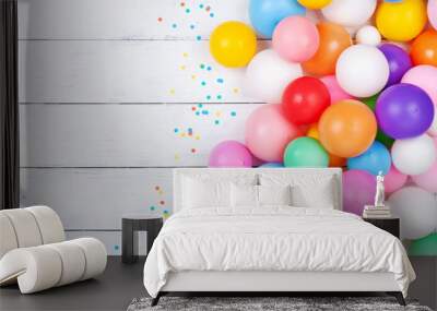 Colorful balloons and confetti on white table top view. Festive or party background. Flat lay. Birthday greeting card. Wall mural