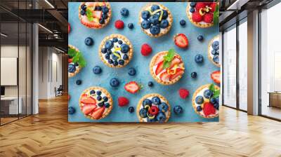 Colorful berry tartlets or cake for kitchen pattern. Pastry dessert from above. Wall mural