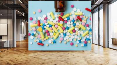 colorful drug pills on blue background, pharmaceutical concept Wall mural