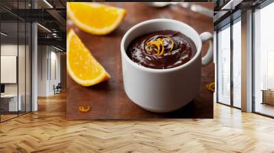 Delicious dessert from dark chocolate mousse with orange slice decorated citrus peel on rustic table Wall mural