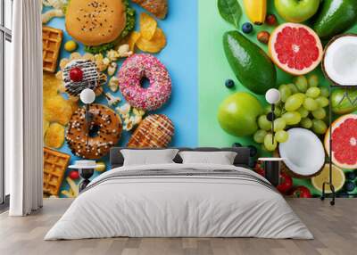 Healthy and unhealthy food background from fruits and vegetables vs fast food, sweets and pastry top view. Diet and detox against calorie and overweight lifestyle concept. Wall mural