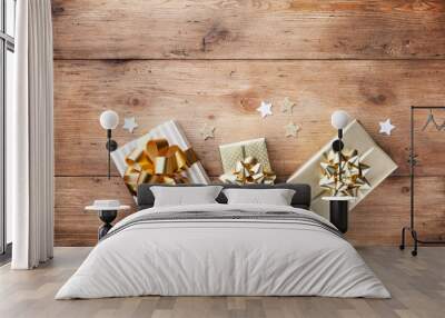 Heap of gift or present boxes and stars confetti on wooden table top view. Festive composition for birthday, christmas or wedding. Wall mural