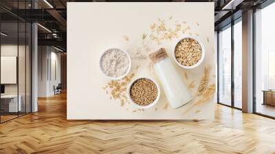 Oat milk, flour, dry flakes and whole grains top view. Set from organic oat products for vegetarian and healthy food. Wall mural