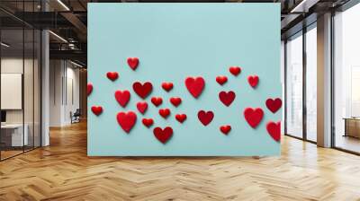 Valentine day greeting card or banner. Red hearts on blue background top view. Flat lay style. Wall mural