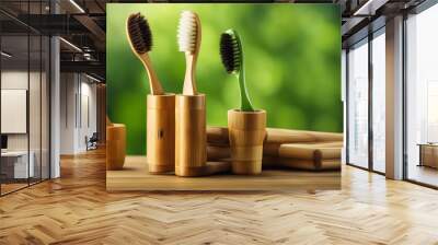 Eco-friendly bamboo toothbrushes on a wooden surface against a green, natural background, symbolizing sustainability and care for the environment Wall mural