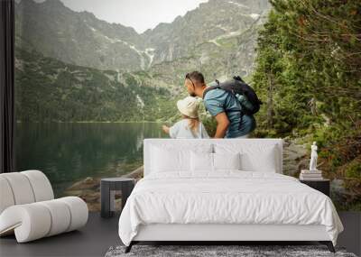 Man and child tourists in mountains at Morskie Oko lake near Zakopane, Tatra Mountains, Poland. Family travel concept. Wall mural