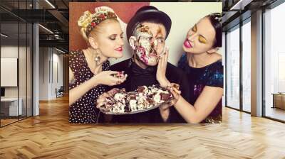  sweet relations, women smear cake on a man's face Wall mural