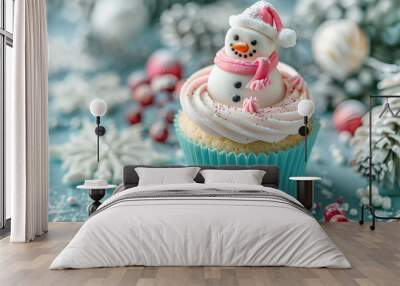 Festive cupcake decorated with a cute snowman made of icing, surrounded by Christmas-themed decorations in a wintery setting. Wall mural