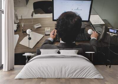 Businessman working in his office Wall mural