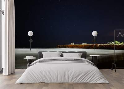 Sandy beach under a starry sky at night Wall mural