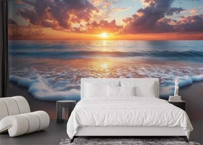 Serene sunset over the ocean with gentle waves on the shore. Wall mural