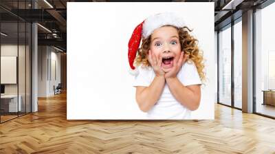 excited curly child in santa hat white background Wall mural