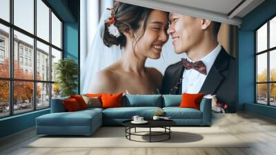 A bride and groom stand close together, exchanging smiles and gazing warmly at each other. Their expressions exude joy and love on their wedding day. Wall mural