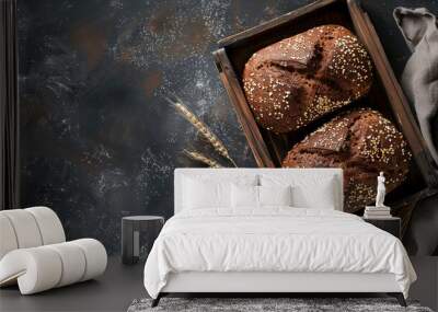 Two sourdough bread on a wooden tray with wheat and towel on dark background. Handmake bakery bread  recipe concept. Flat lay, panoramic top view. copy space. Wall mural