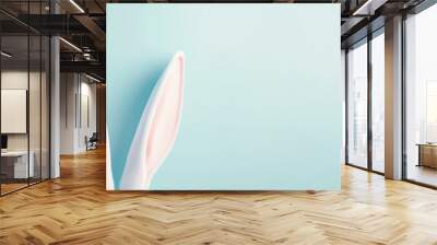 Bunny ears on blue background. Space for text. Wall mural