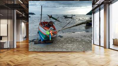 alone Fishing boat on the beach cloudy background Wall mural