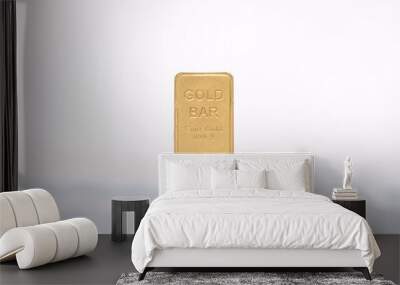 A hand holding a gold bar. Wall mural