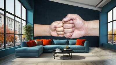 A Fist Of A Child And An Adult Male,Competition And Victory Concept Wall mural