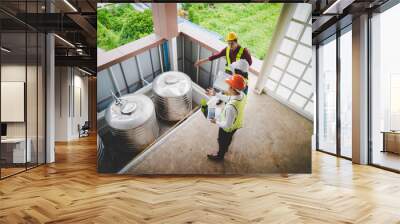 Three contractor engineer and worker is checking the water system of an industry building. Wall mural